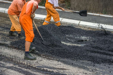 Road construction crew apply the first layer of asphaltの写真素材