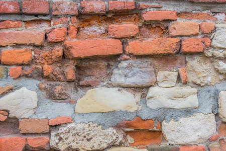 Damaged brick wall with stons background
