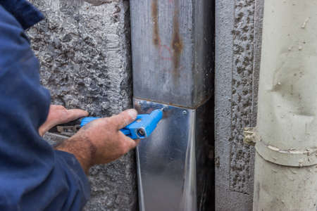 fixing a leaky gutter downspout, fixing a leaky gutter, Patching Leaking Guttersの写真素材