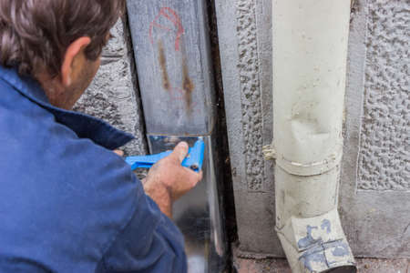 fixing a leaky gutter downspout, fixing a leaky gutter, Patching Leaking Guttersの写真素材