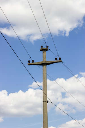 Concreet electrical pole with power lines 2 and sky background. Selective focus.の写真素材