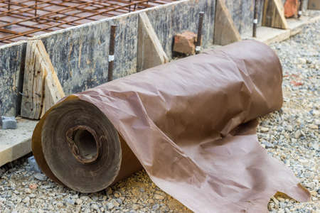 Waxed paper underlayment for concrete slab installation, moisture barrier during concreting floors pouring works. . Selective focus and shallow dof.の写真素材