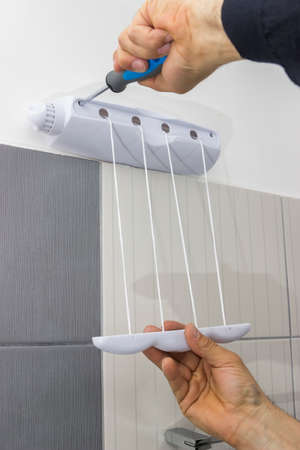 Installing bathroom accessories on bathroom wall. Selective focus.の写真素材
