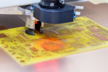 CNC Drill Machine drilling a printed circuit board. Selective focus and shallow dof.の写真素材