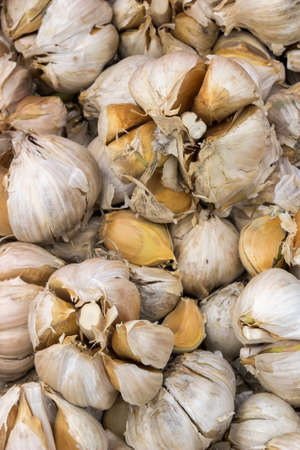 Bunch of big garlic heads at a street market, selective focus.の写真素材