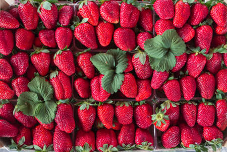Fresh strawberry in wooden box for sale at a street market, background.の写真素材
