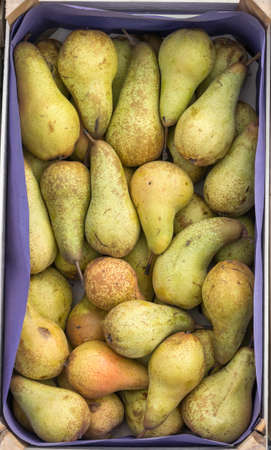 Pears in wooden crate for sale  at a street market. Background.の写真素材
