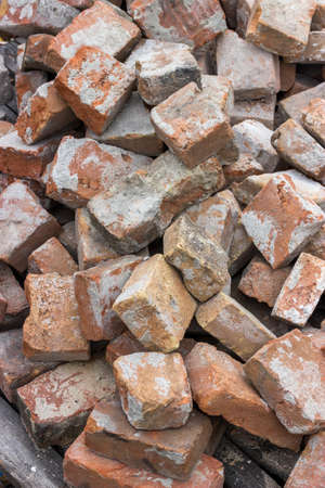 Pile of used red brick, used construction material. Selective focus and shallow dof.の写真素材