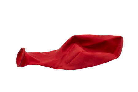 Red deflated rubber balloon isolated on white の写真素材