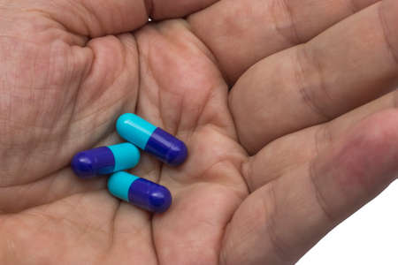 antibiotic pills in a hand closeup, capsules therapyの写真素材