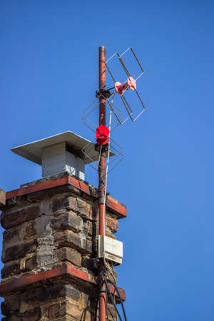 old analog TV antennas on house chimneyの写真素材