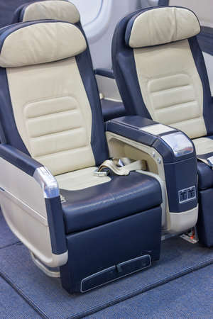 Empty comfortable business class airline seats, airplane interior.の写真素材