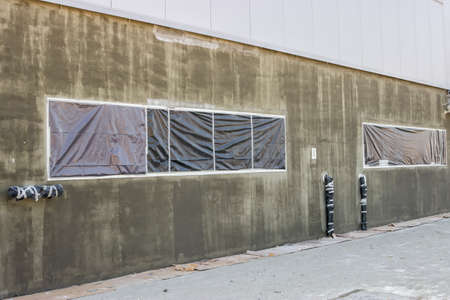 Exterior wall  with protected areas from application of all types of facade colors and plasters. Nylon protective foil before painting.の写真素材