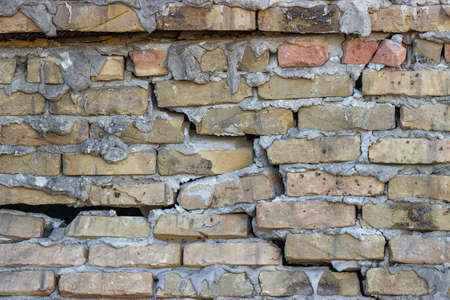 Broken brick wall background. Cracked brick wall.の写真素材