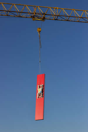 lifting sandwich panels for the walls by crane at the building site  with sky in backgroundの写真素材