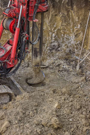 Drilling hole in ground with ground hole drilling machine. Motion blur on drill pipe and drill bit.の写真素材
