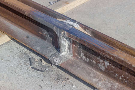 Laying tramway track, just grinded rail. Installation of tram tracks. Assembling a tram rail track.の写真素材