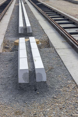 Concrete curb stones at tramway track construction site. Installing new street.の写真素材