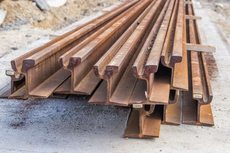 Heap of steel rusty tram rails, ready to be installedの写真素材