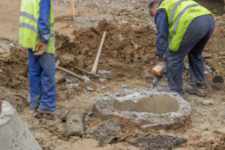 jackhammer concrete, builder workers with electric jackhammer breaks concrete. Selective focus.の写真素材