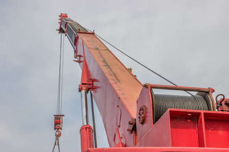 Crane arm with hook, part of heavy truck. Selective focus.の写真素材