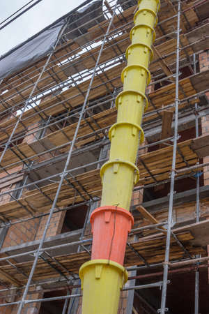 Garbage tube to dump debris at construction site. Debris tube for transporting debris from upstairs.の写真素材