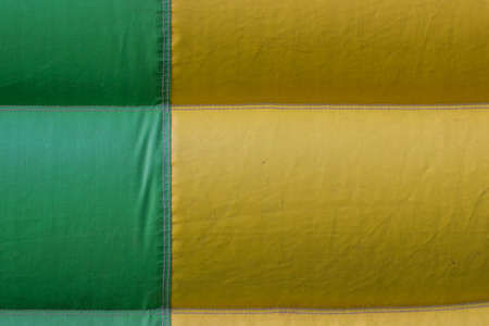 green yellow PVC tarpaulin detail background, material on inflatable jumping castleの写真素材