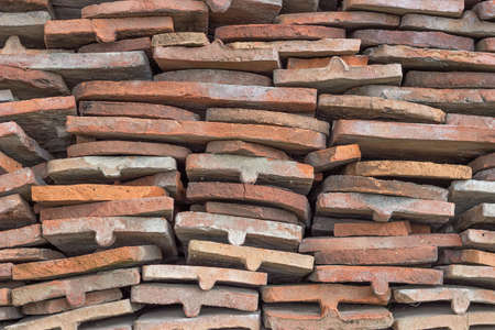 heap of old terracotta tile roof backgroundの写真素材
