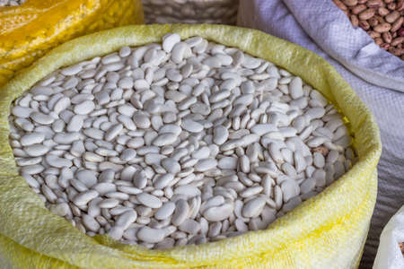 Farmers market white beans in sack. At the farmers market local growers come and sell their freshly picked crops at reasonable prices. Selective focus.の写真素材