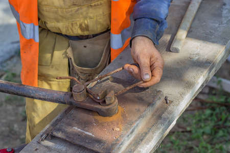 Worker bending spacers for the rebars in a concrete post. Selective focus and motion blur.の写真素材