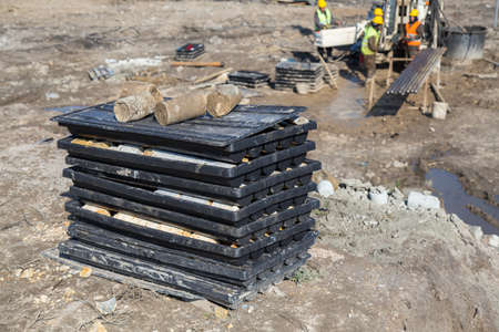 View of the drill core samples with drill crew working in background. Core samples will determine...