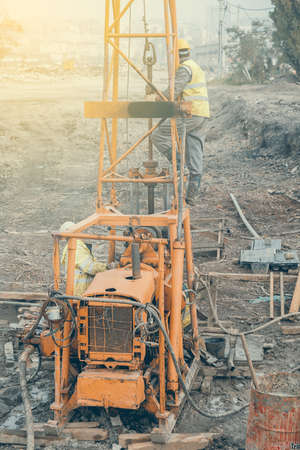 Workers on an old on core drilling rig, vintage style.の写真素材
