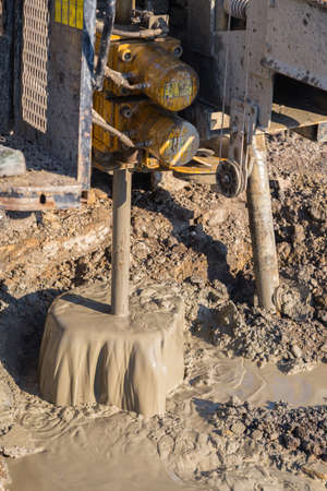 Drilling thru hard rock, geotechnical drilling compact rig at work. Selective focus.の写真素材