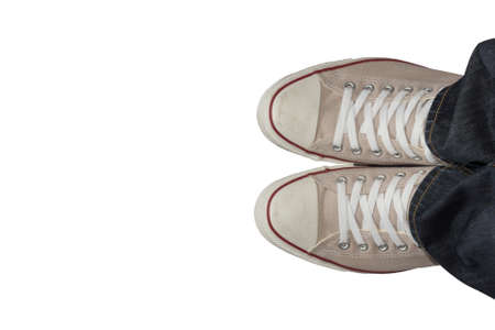 Feet in sneakers from above. isolated on white background. and made with selective focus.の写真素材