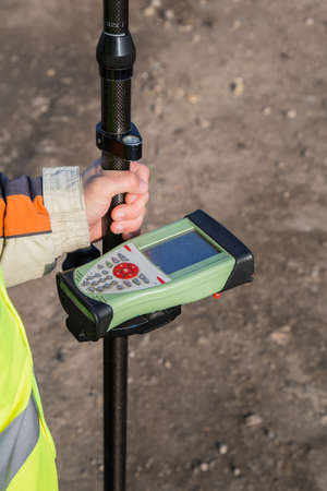 GNSS receiver with field controller on smart pole for surveying. GPS surveying instrument. Selective focus.の写真素材