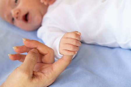 Baby baby holding the mother finger, maternity concept.の写真素材