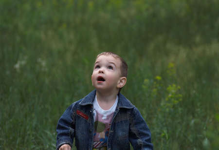 my nephew runs on a grass in park of city Ust-Kamenogorskの写真素材