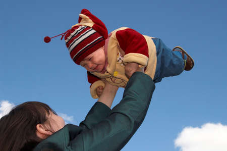 The mother and child on a background of the dark blue skyの写真素材