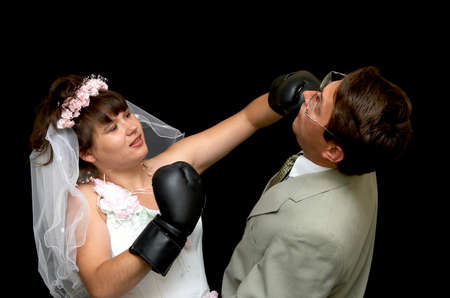 The aggressive bride and groom on a black backgroundの写真素材