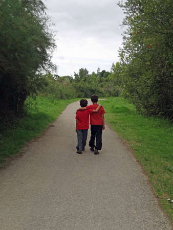 two children walking along a path                               の写真素材