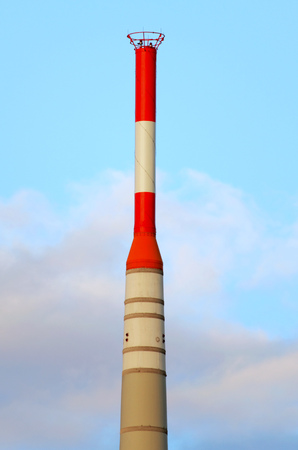 top of a television tower with red and white warning markingsの写真素材