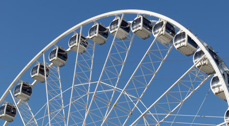 Ferris wheel on the beach of scheveningen in front of a blue skyのeditorial素材
