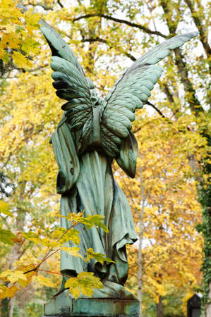 an angel figure in an autumnal cemeteryの写真素材