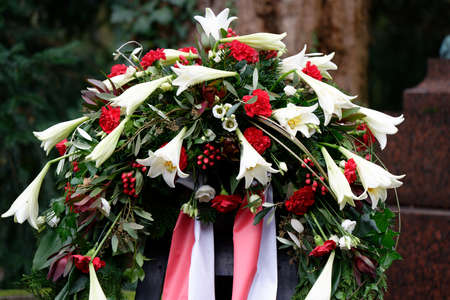 funeral wreath with bow on a grave after a funeral