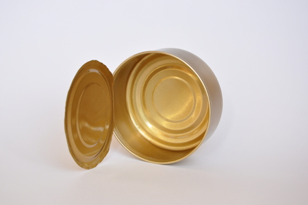 Empty tin can lying on its side isolatedの写真素材