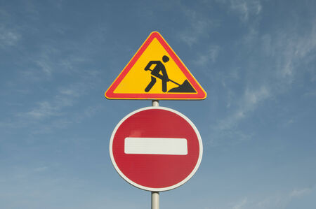 road sign forbidding movement in connection with repairs, in the background of the blue skyの写真素材
