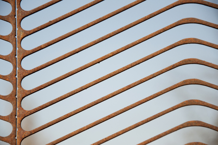 rusty metal fence on the background of blue sky