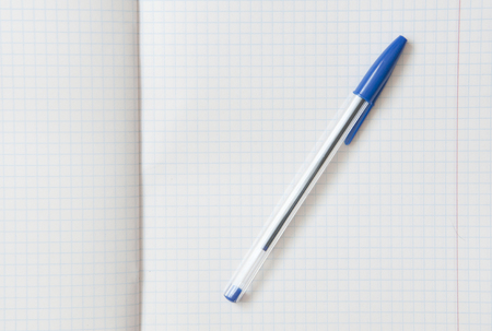 pen with a blue cap lies at the expanded notebookの写真素材