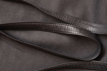 black leather texture background with leather straps