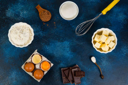 The ingredients for making chocolate brownie are on the table. Butter, eggs, flour, sugar, chocolate and cocoa. Horizontal orientation with copy spaceの写真素材